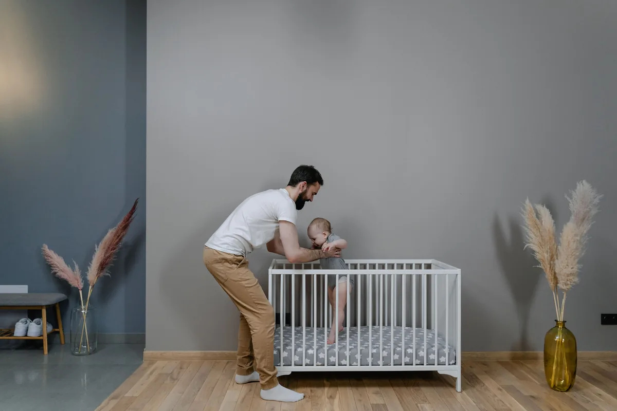 Padre o pareja haciendo la rutina de la noche con el bebé, leyendo o cantando antes de dormir